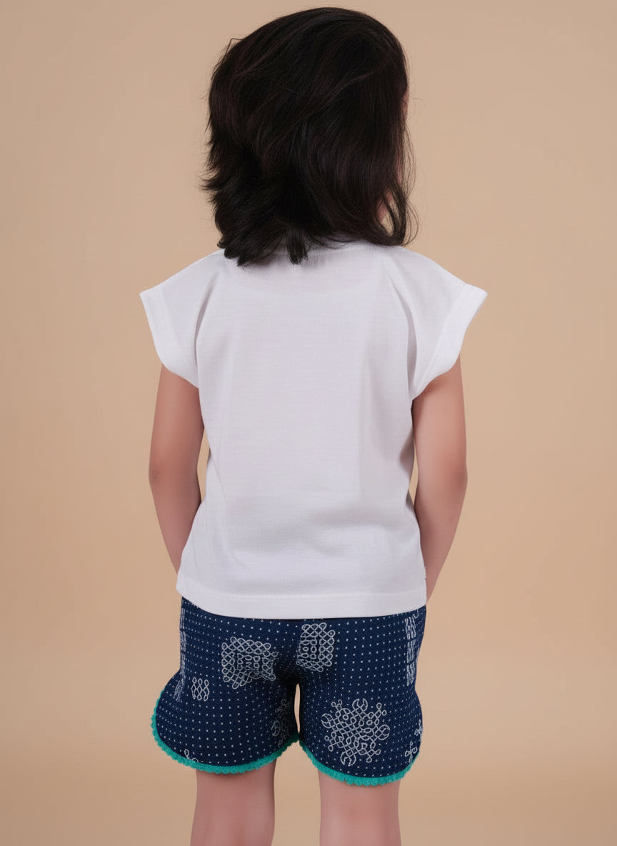 Person wearing a white top and blue patterned shorts on a gray background