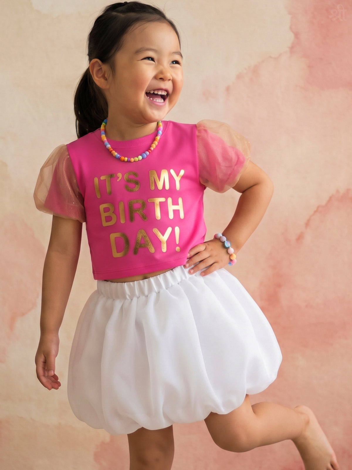 A young girl posing in Birthday Co-ord  from Pink Skies Collection by Little Carrot