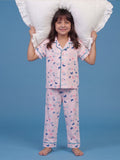 A girl posing in a playful pose with pillow wearing Little Carrot Butterfly printed night suit in peach color