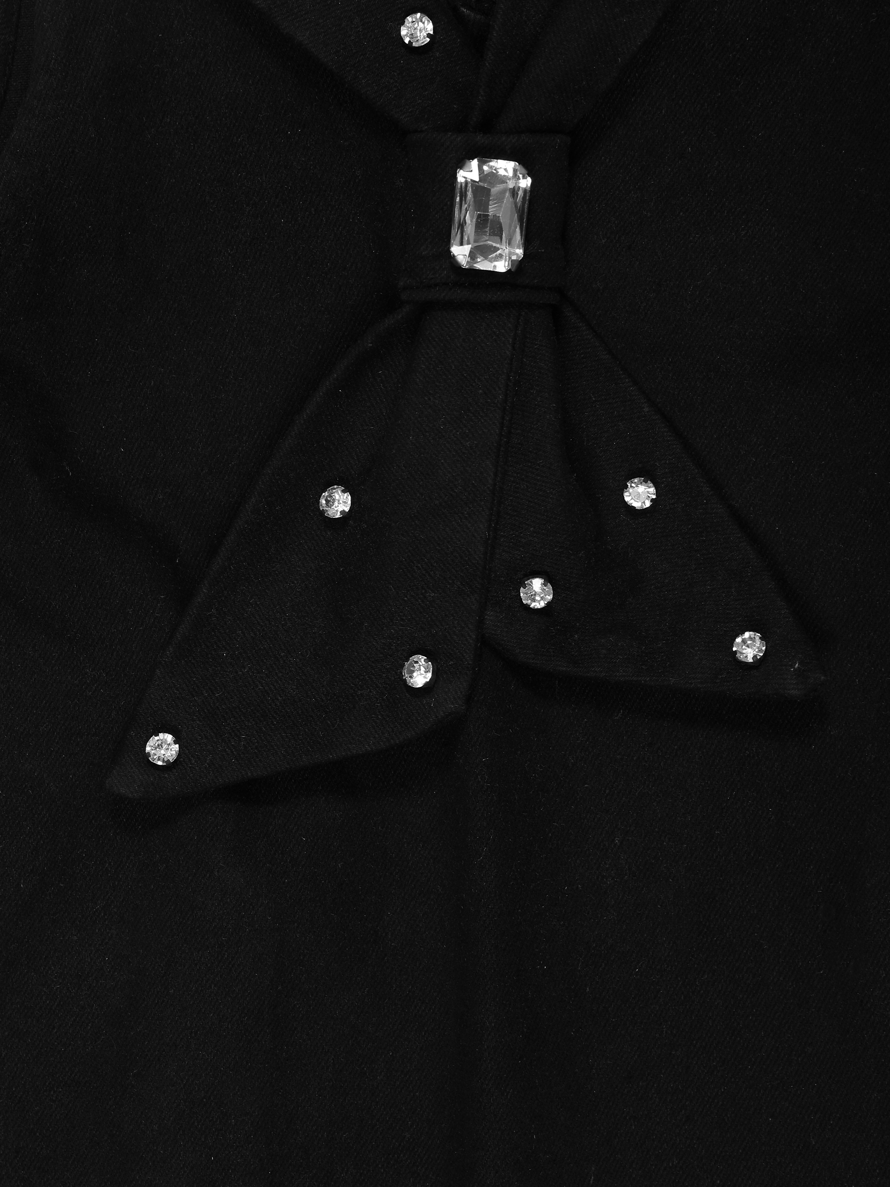 Black bow tie of Little Carrot Denim Dress with crystal-like stones on a black background