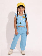 Child wearing a blue Little Carrot outfit with a sun and cloud handmade crochet patches, standing against a plain background