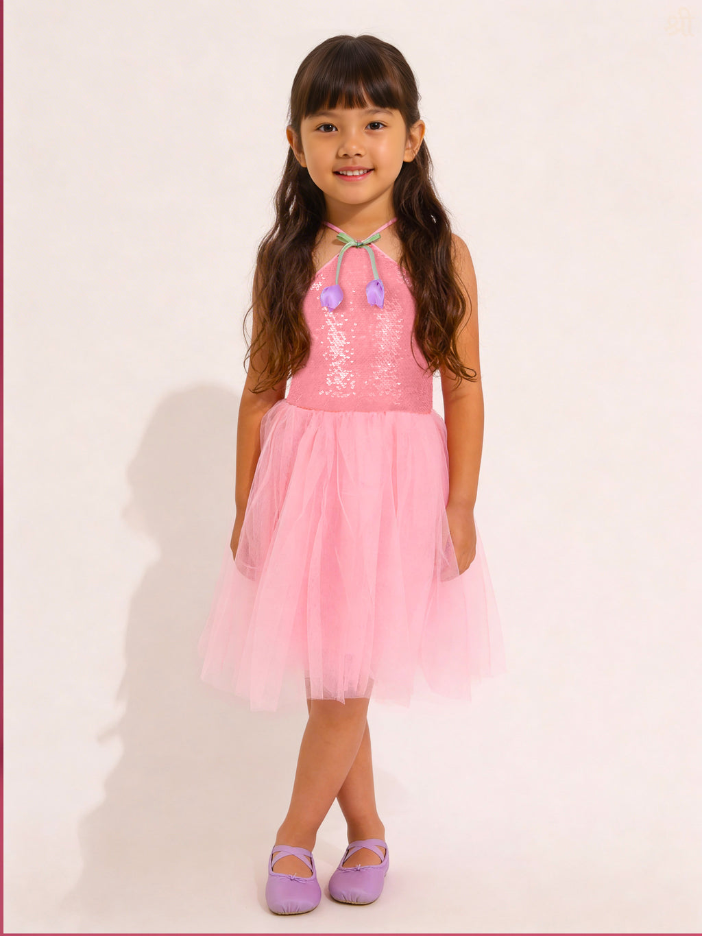 Young girl wearing a Little Carrot pink Sequins Tulle Partywear dress with a white background
