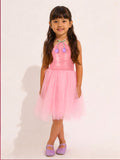 Young girl wearing a Little Carrot pink Sequins Tulle Partywear dress with a white background