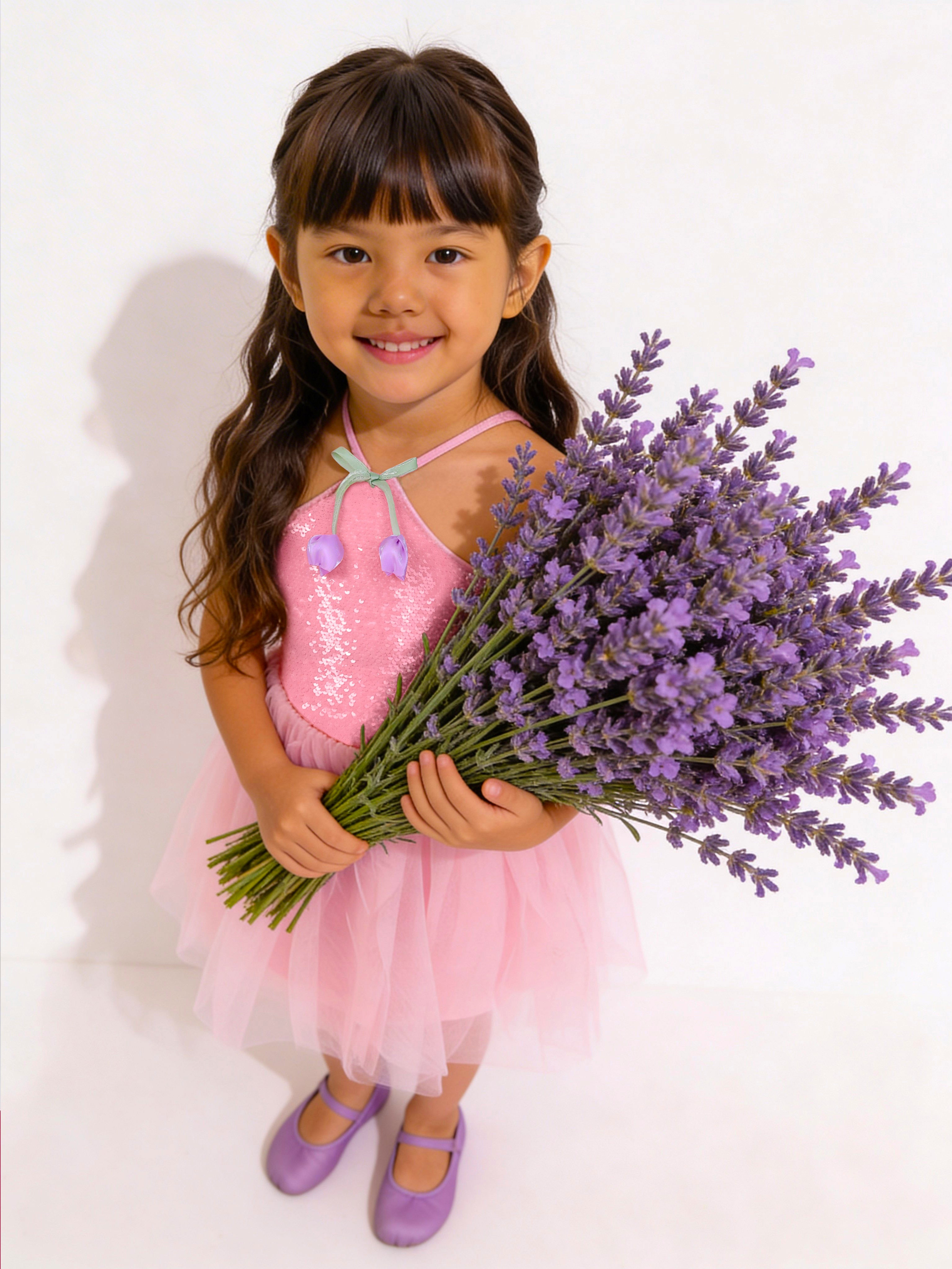 Young girl in a Little Carrot Sequins Tulle Partywear pink dress holding a bouquet of lavender flowers on a white background