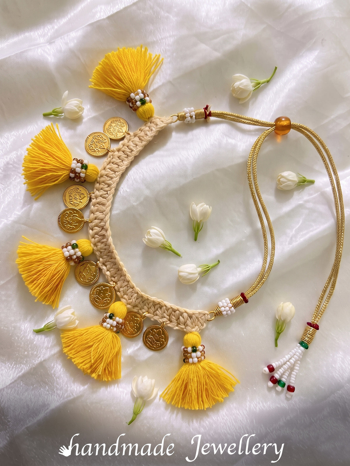 Shoot of Little carrot handmade cotton crochet necklace with tassles and coin detailing