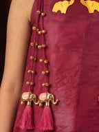 A young girl posing in Little Carrot Kurti Palazzo Set with elephant and ghungroo Detailing