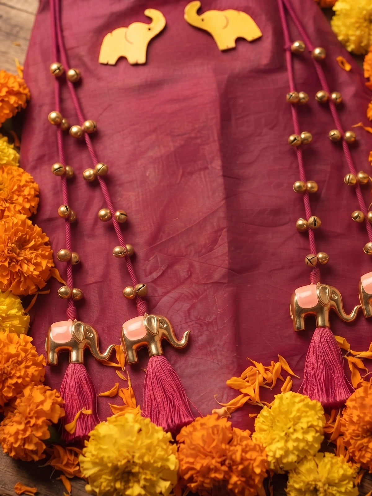 A young girl posing in Little Carrot Kurti Palazzo Set with elephant and ghungroo Detailing