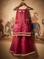 A young girl posing in Little Carrot Kurti Palazzo Set with elephant and ghungroo Detailing