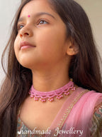A girl highlighting Little Carrot crochet handmade lavender necklace