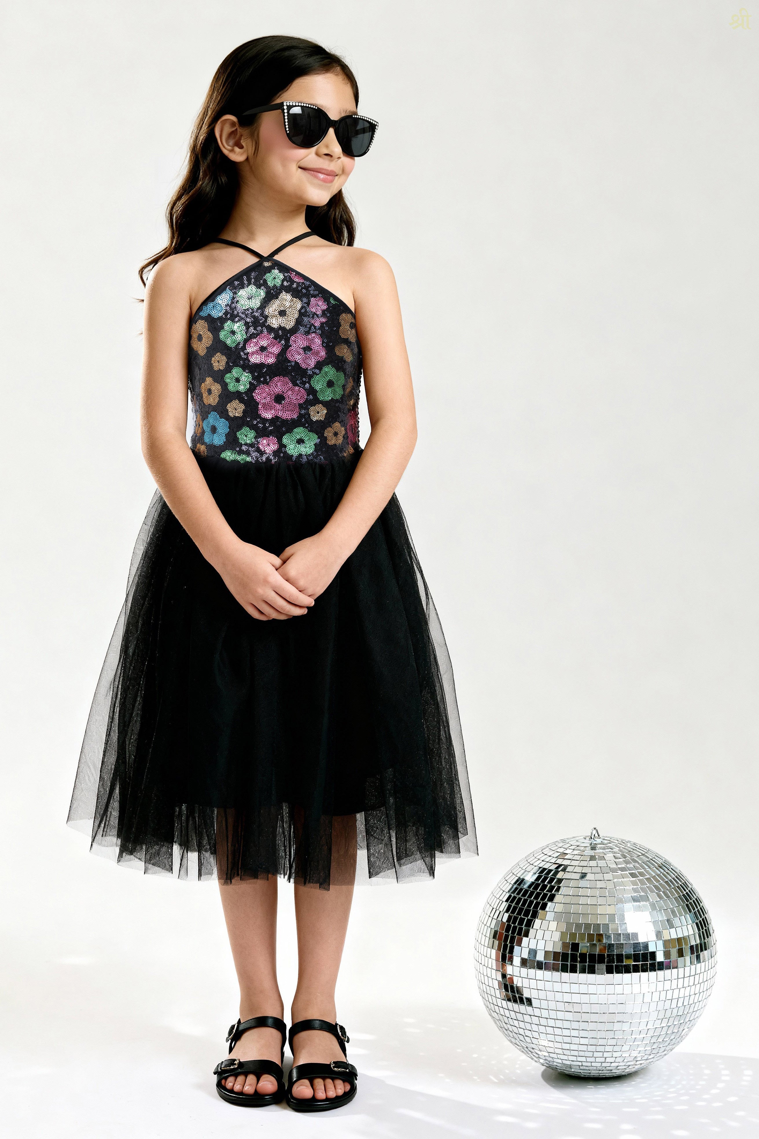 Young girl wearing a Little Carrot floral patterned Sequinned Tutu Dress on a white background