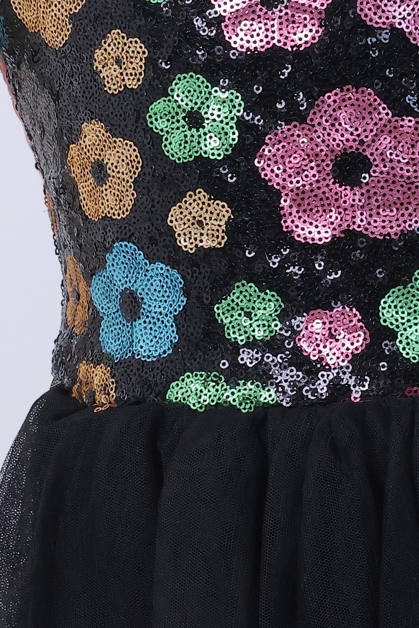 Young girl wearing a Little Carrot floral patterned Sequinned Tutu Dress on a white background