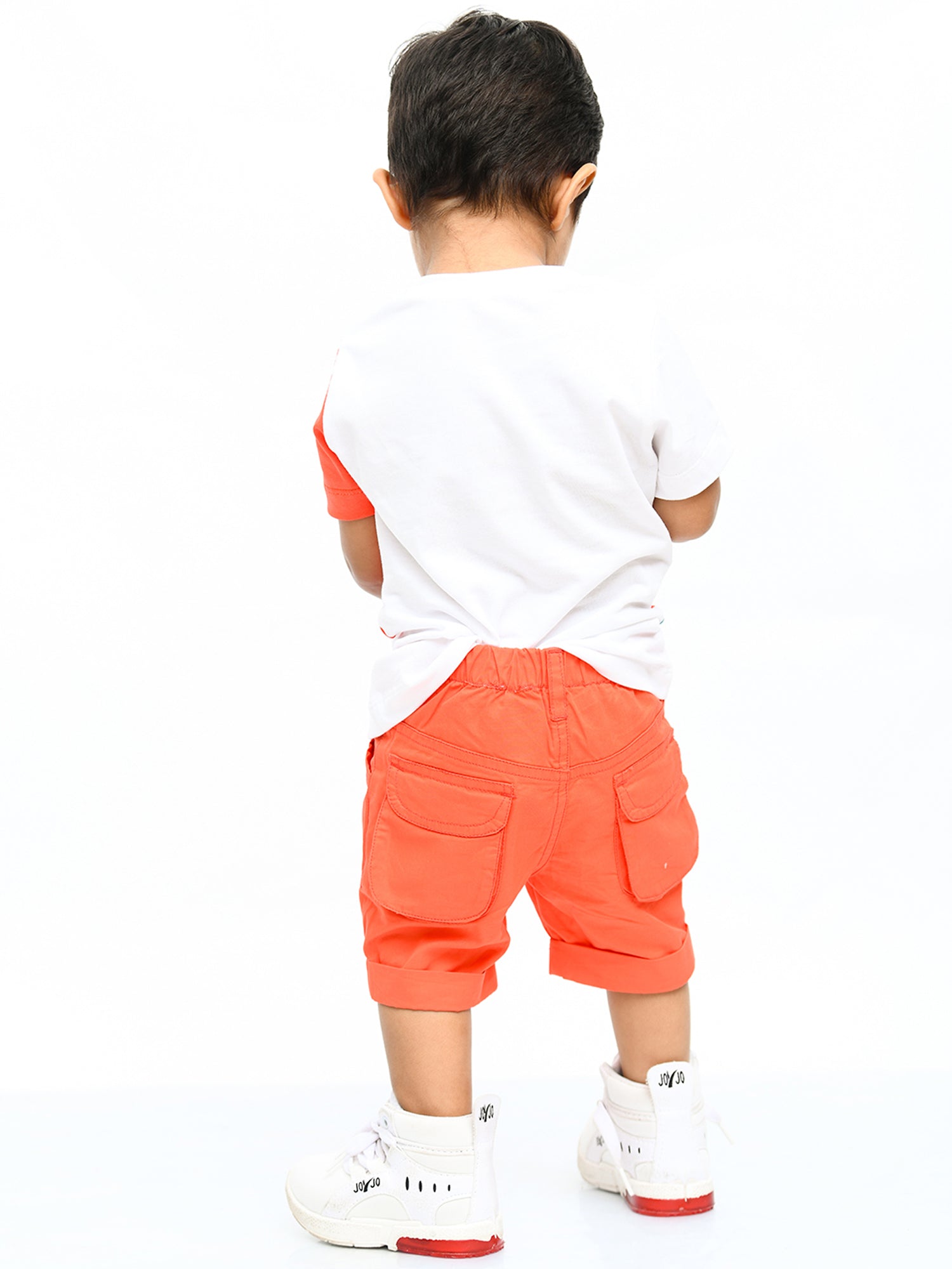 Infant boy wearing a cheerful orange sunshine co-ord set with playful cartoon print – ideal cotton outfit for toddlers in summer