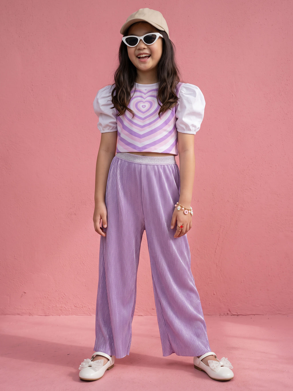A young girl posing in Little Carrot Heart Printed Glitter Co-ord Set