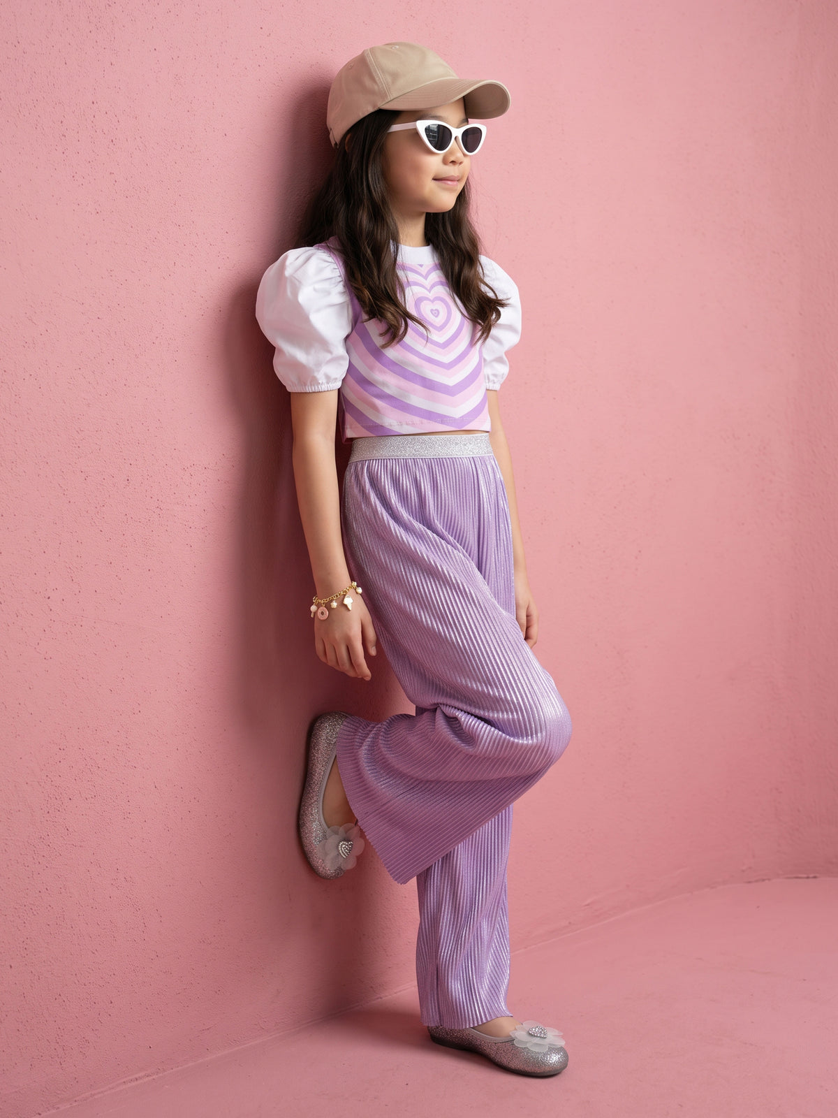 A young girl posing in Little Carrot Heart Printed Glitter Co-ord Set