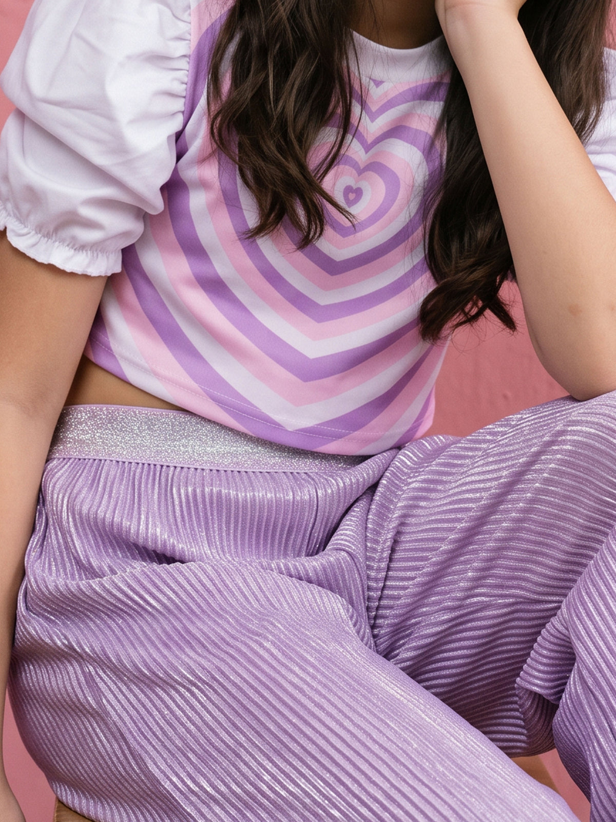 A young girl posing in Little Carrot Heart Printed Glitter Co-ord Set