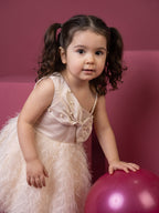 A young girl posing in Satin bow and Fur Flare Dress from Pink Skies Collection by Little Carrot