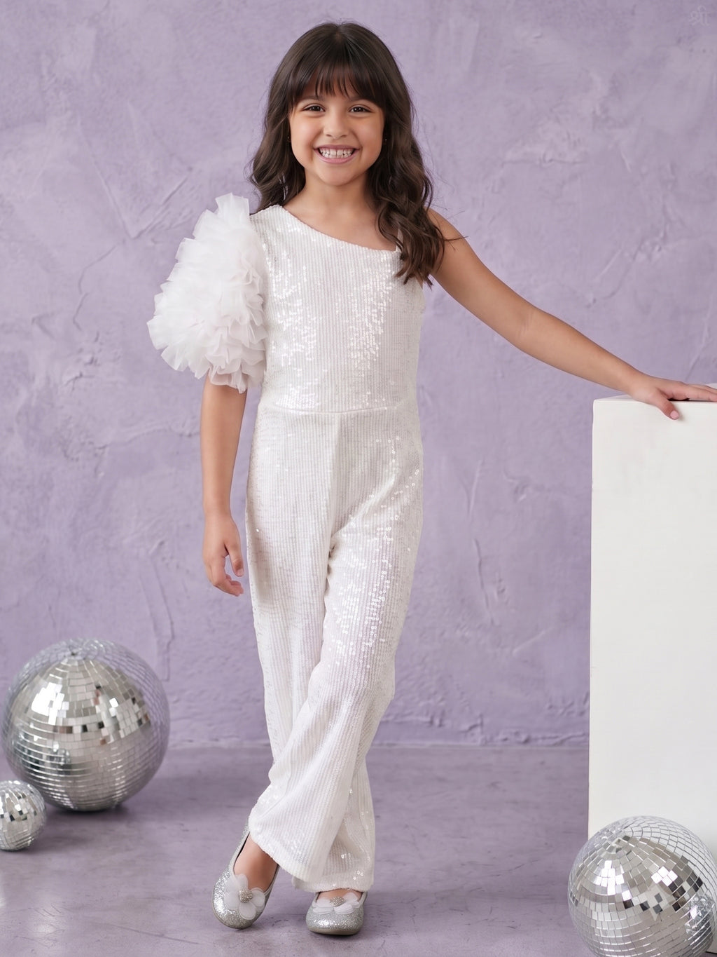 A Young happily posing in a Little Carrot White Sequins Jumpsuit