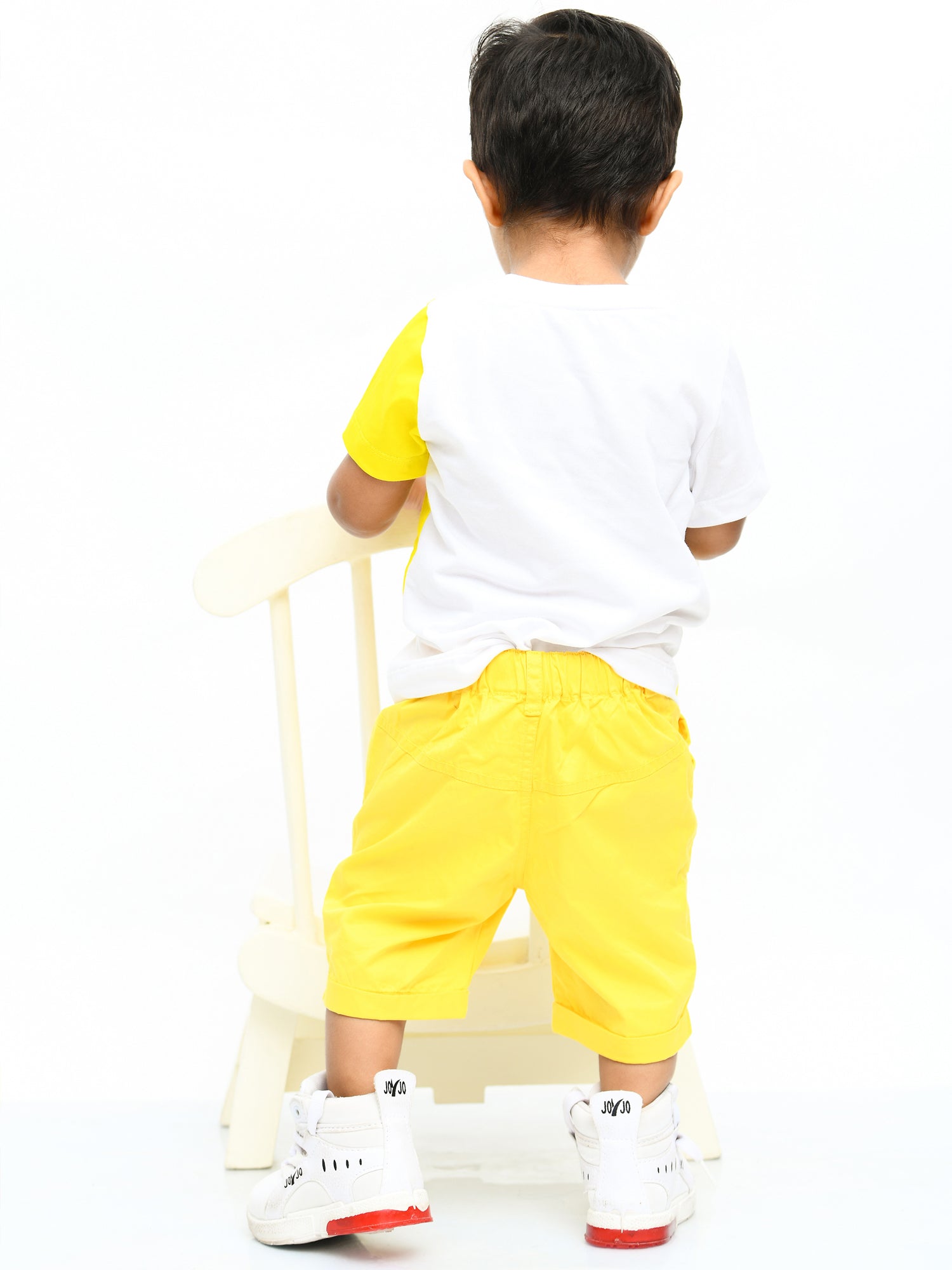 Infant boy wearing a bright yellow sunshine-themed co-ord set with fun cartoon print – perfect cotton outfit for playful summer days