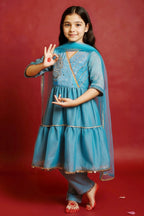 Girl wearing blue Anarkali kurta set with sequins, cord work, lace detailing, straight pants and dupatta by Little Carrot.