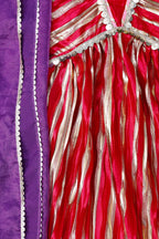 Close-up of a red and gold fabric with purple border