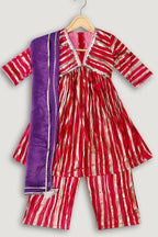 Red and white striped outfit with a purple shawl on a hanger against a light gray background