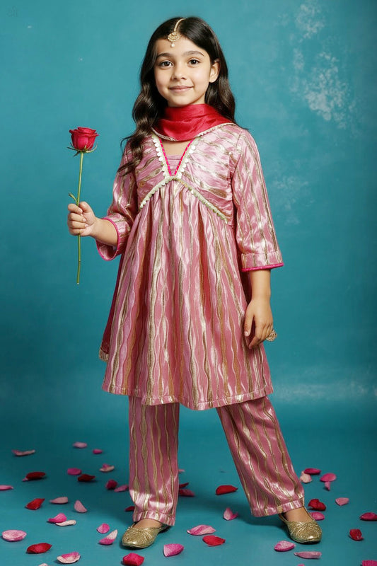 A cute indian standing wearing little carrot Light pink gold Anarkali Kurta Set with Dupatta embellished with laces, with  a red rose in her hand
