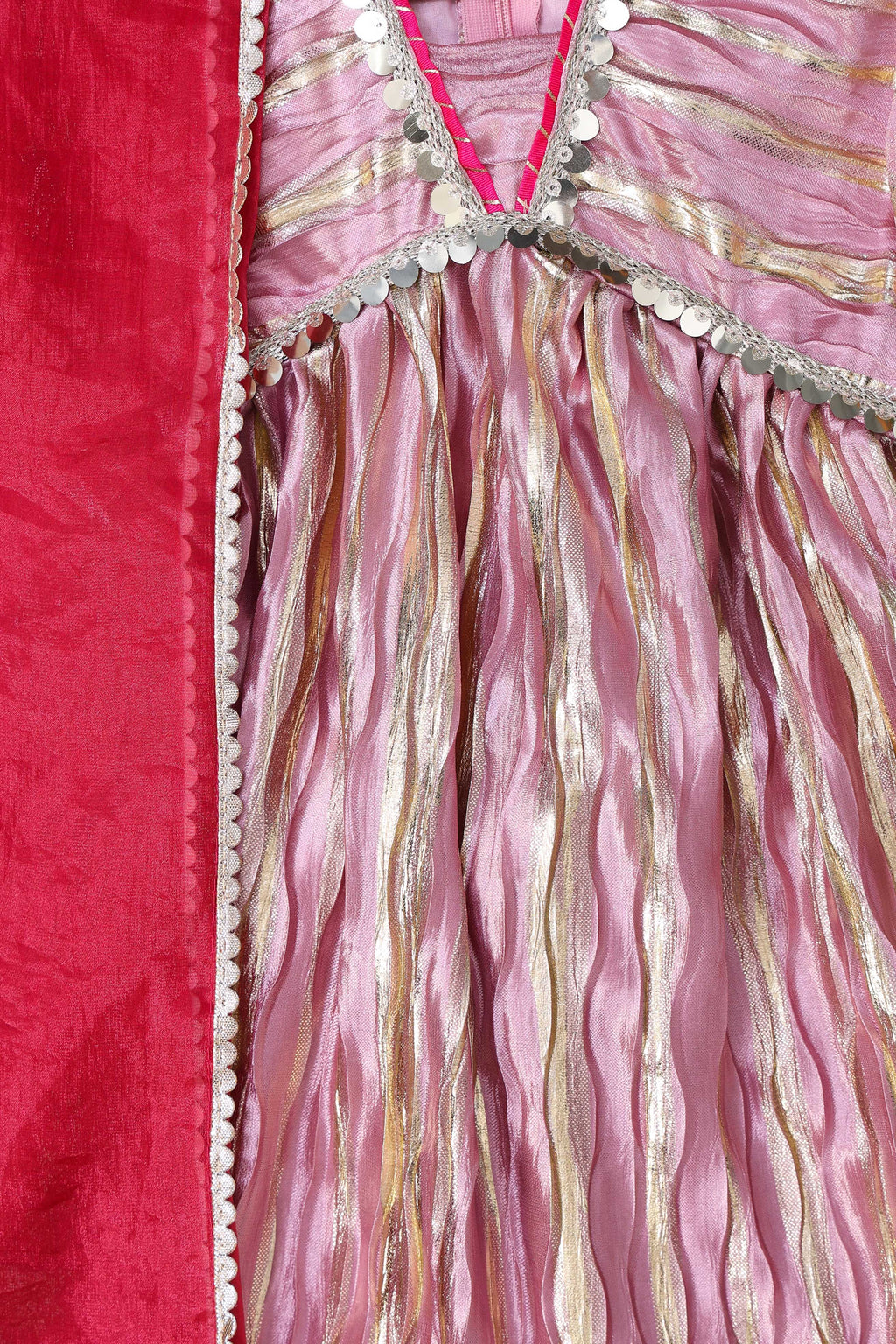 Close-up of a pink and gold fabric with decorative patterns