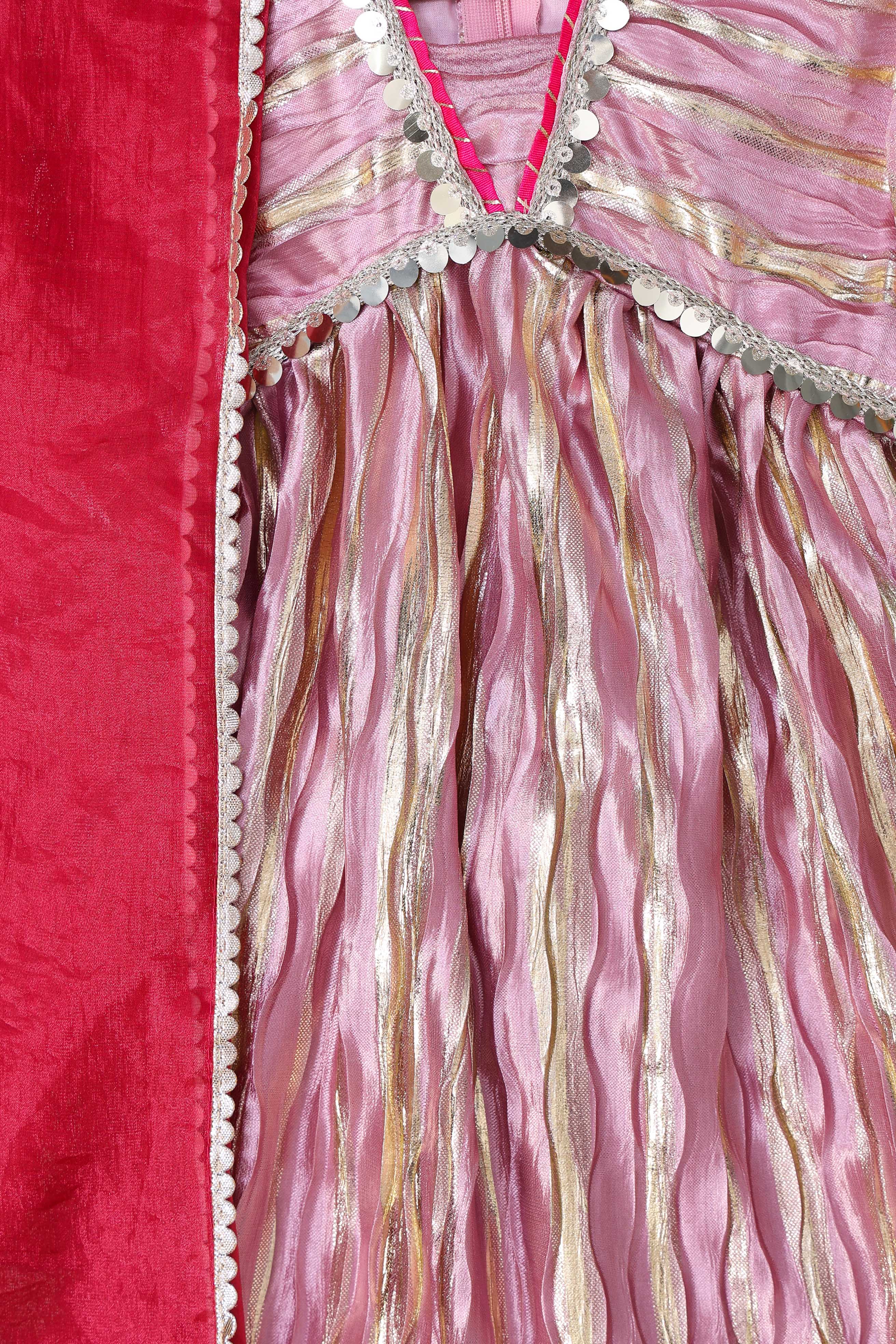 Close-up of a pink and gold fabric with decorative patterns