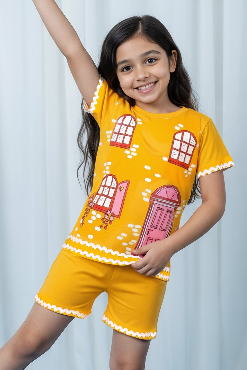 Little Carrot girls yellow printed cotton lounge co-ord set featuring playful house print and scalloped trims