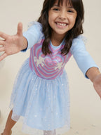 A young happy girl is posing in Little Carrot Blue Unicorn Dress