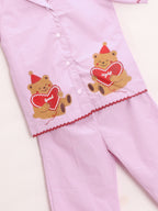 Pink Girl's pajama night suit set with teddy bear designs on a white background
